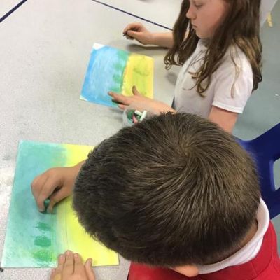 In Art club we used chalk pastels to create poppy fields.