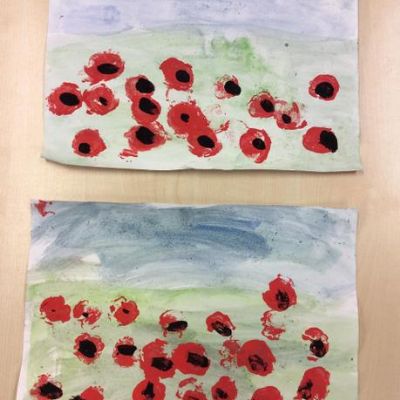 We used watercolours to paint the landscape and then printed poppies using corks.