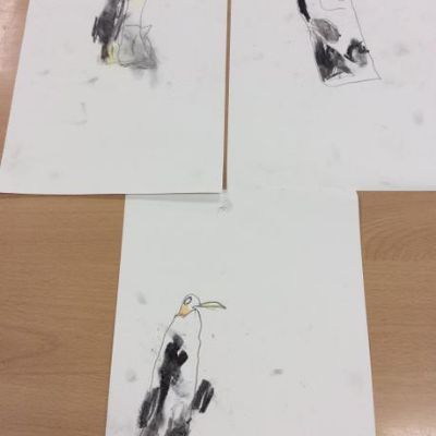 Exploring penguins in charcoal and pastel. Observing 1 bird in front of another.